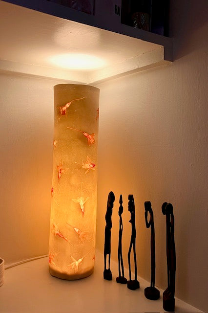 Fuchsia lamp with African Ebony figures within a shelf area