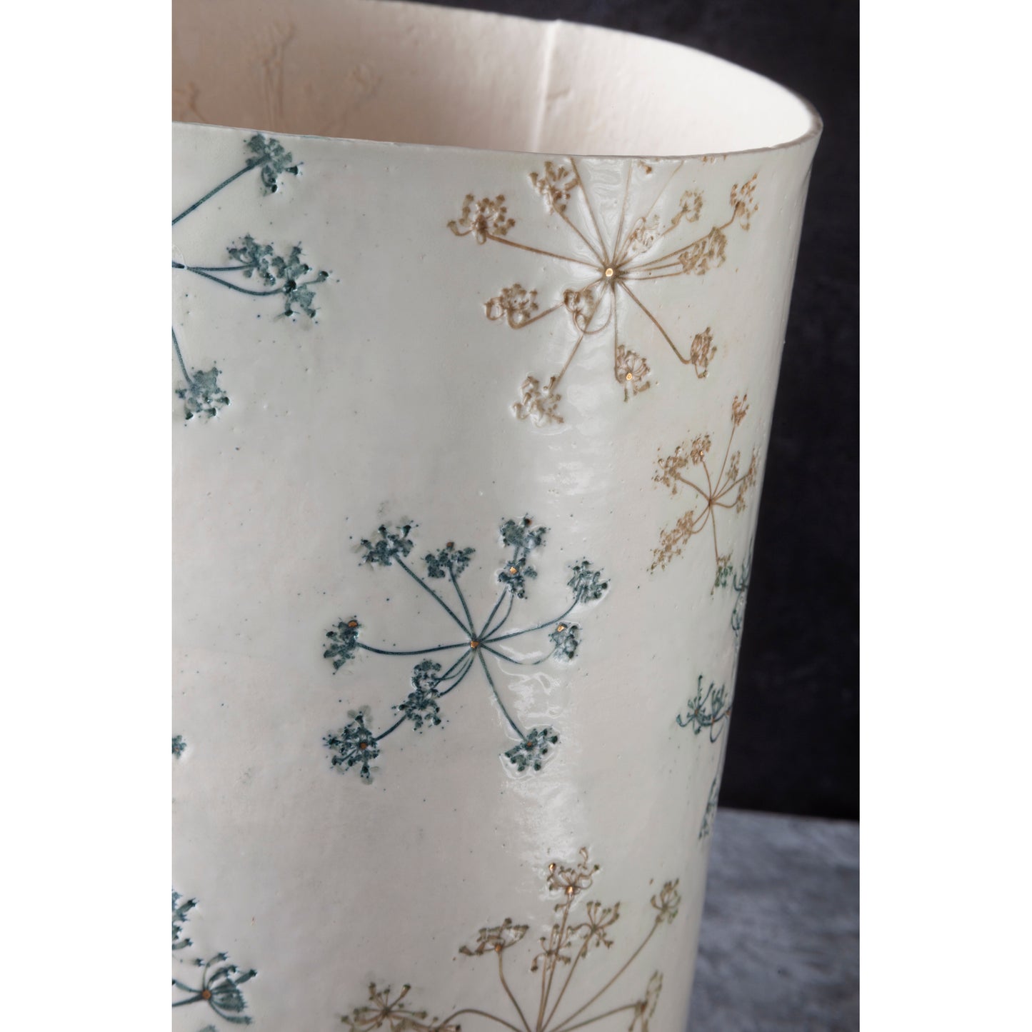 Detail of cylindrical lamp with floral pattern, queen anne's lace, on a white background. unlit