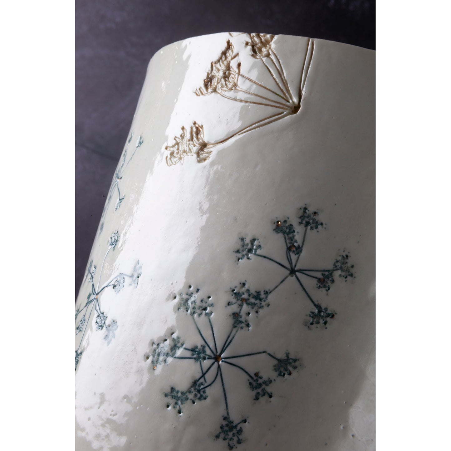 Ceramic lamp with green floral patterns on a white background unlit