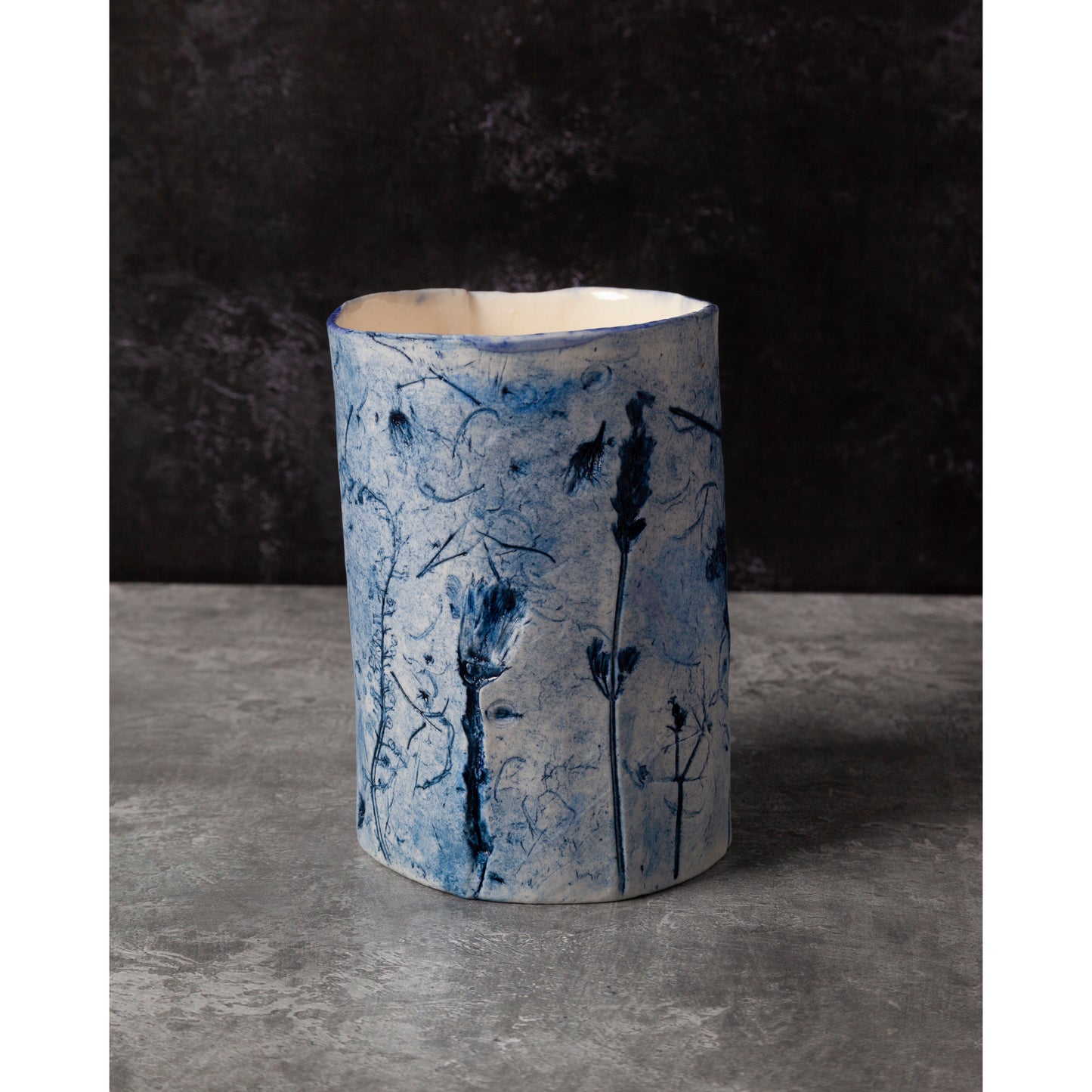 Ceramic vase with blue floral patterns on a dark background