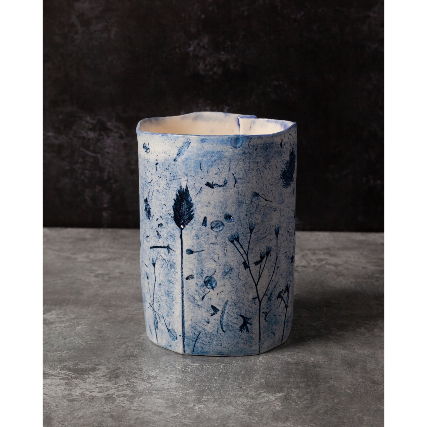 Ceramic vase with blue floral patterns on a dark background