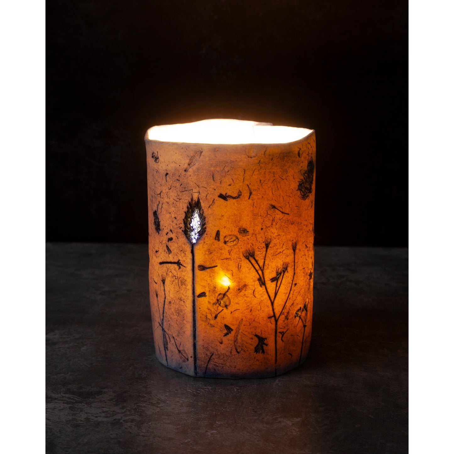 Porcelain Candle holder with decorative design on a dark background