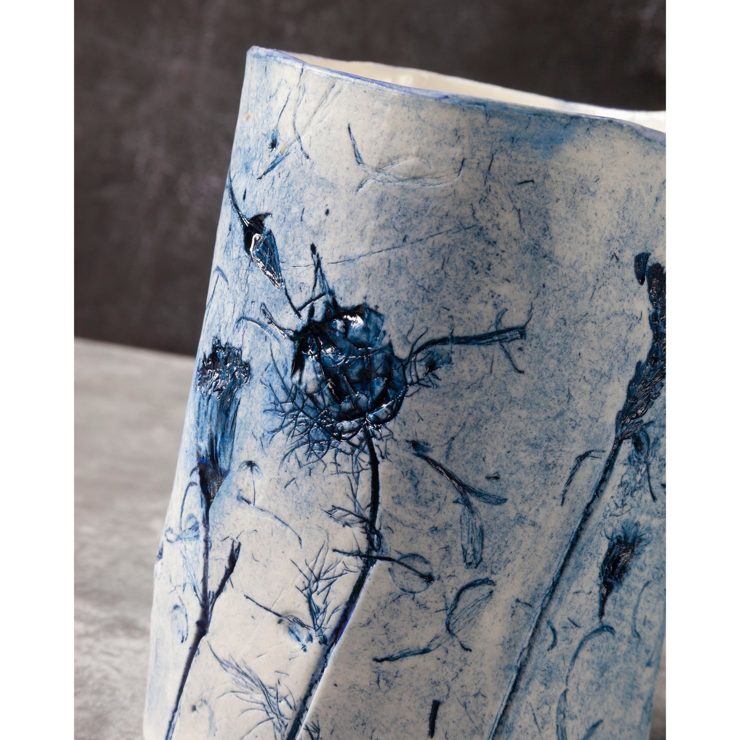 Ceramic vase with blue floral patterns on a neutral background