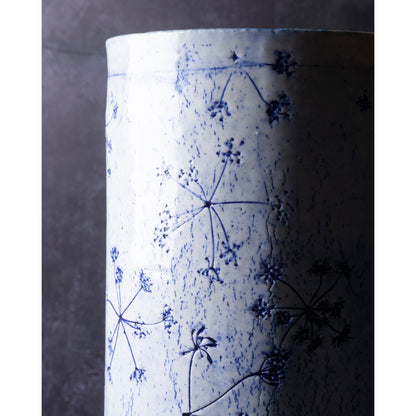 Detail of Porcelain lamp impressed with Queen Anne's Lace flowers. Photographed against a dark background