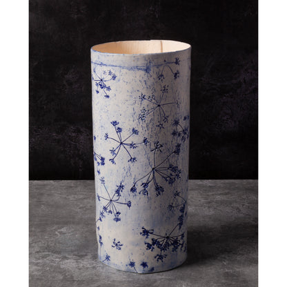 Porcelain lamp impressed with Queen Anne's Lace flowers. Photographed against a dark background