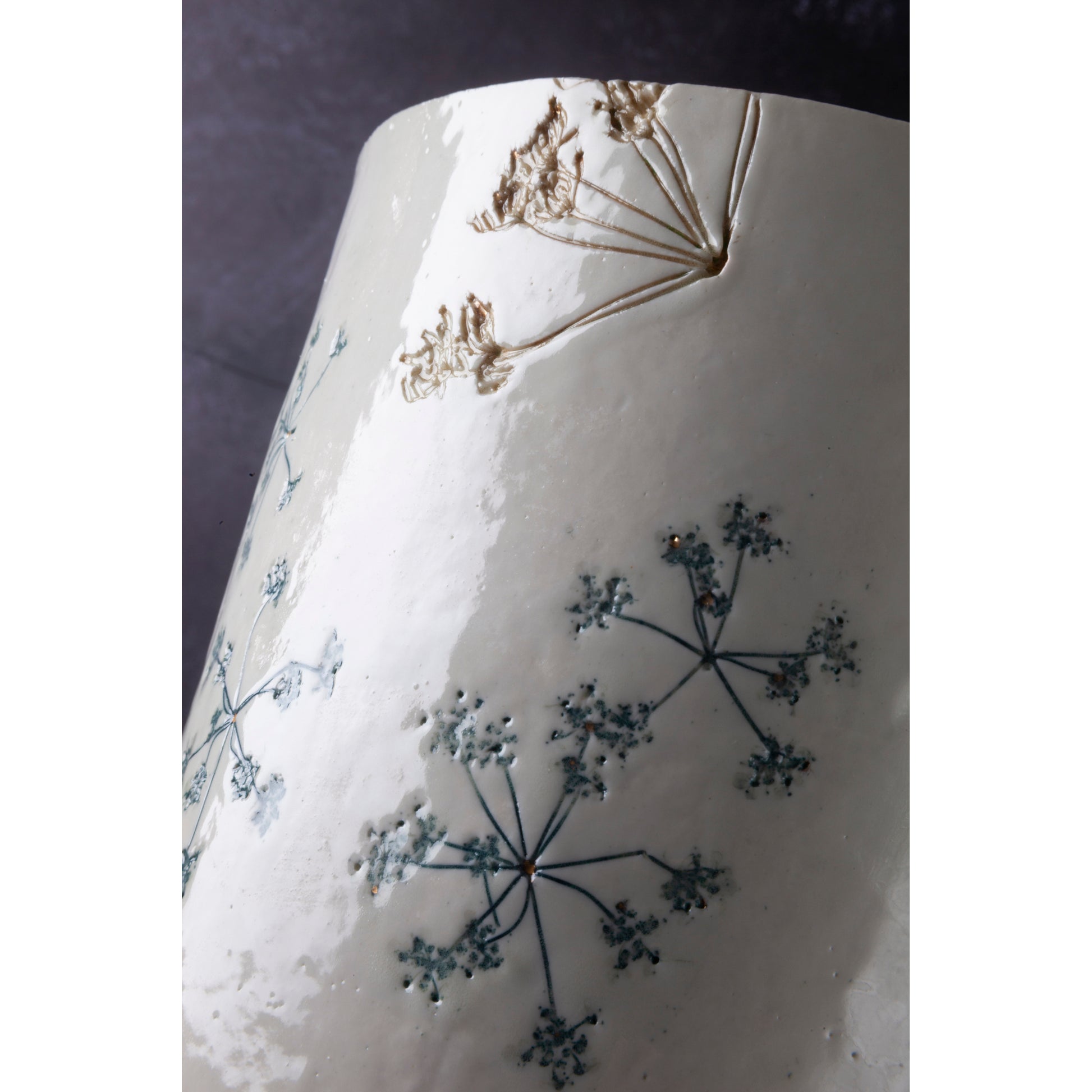 Ceramic lamp with green floral patterns on a white background unlit