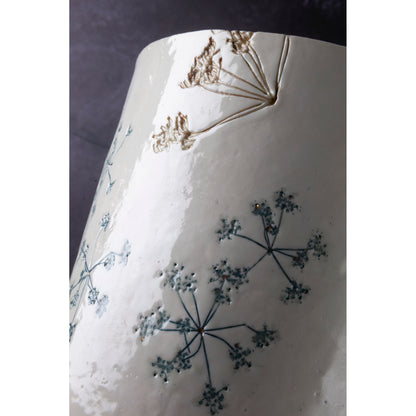 Ceramic lamp with green floral patterns on a white background unlit
