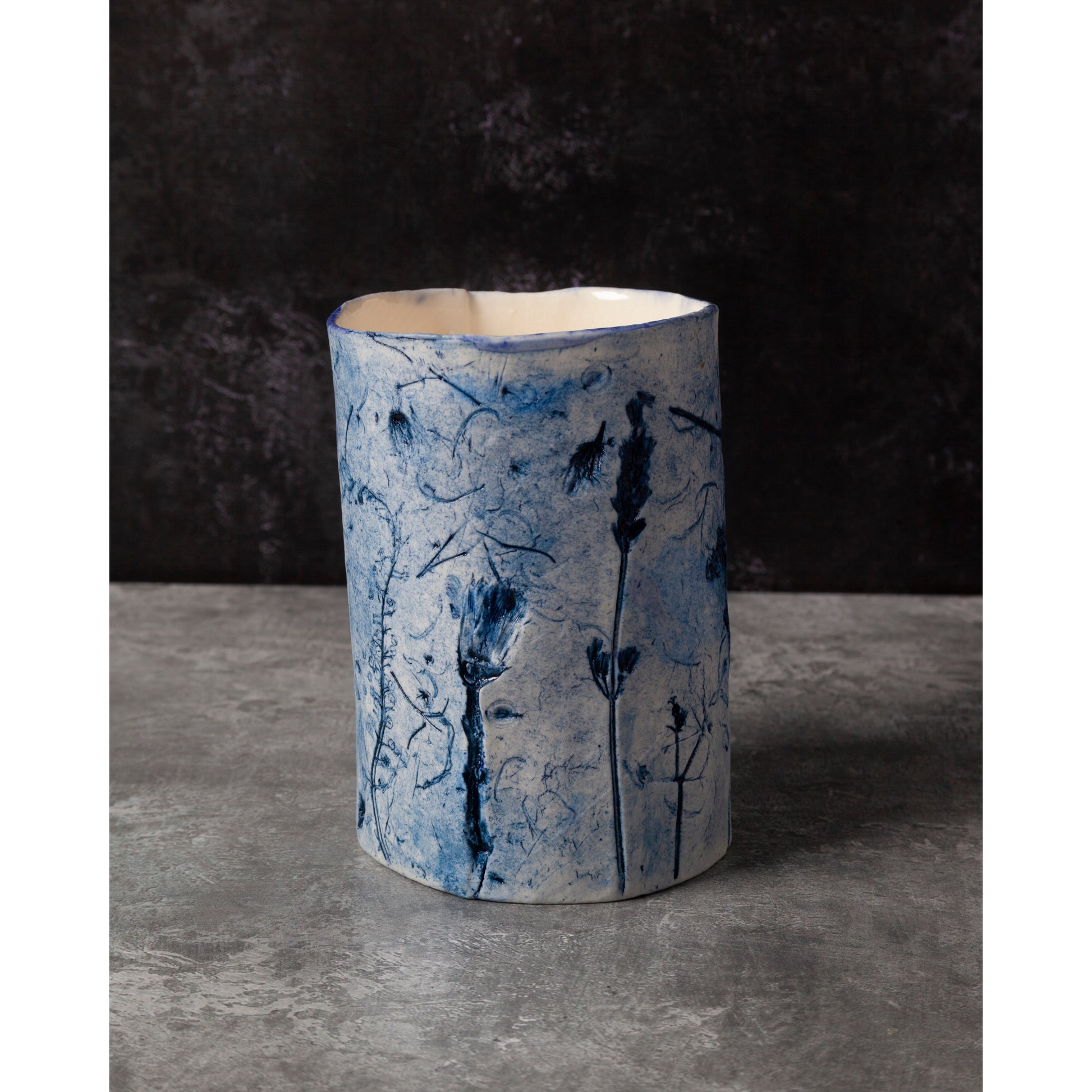 Ceramic vase with blue floral patterns on a dark background