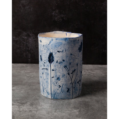 Ceramic vase with blue floral patterns on a dark background
