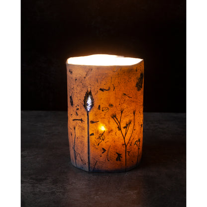 Porcelain Candle holder with decorative design on a dark background