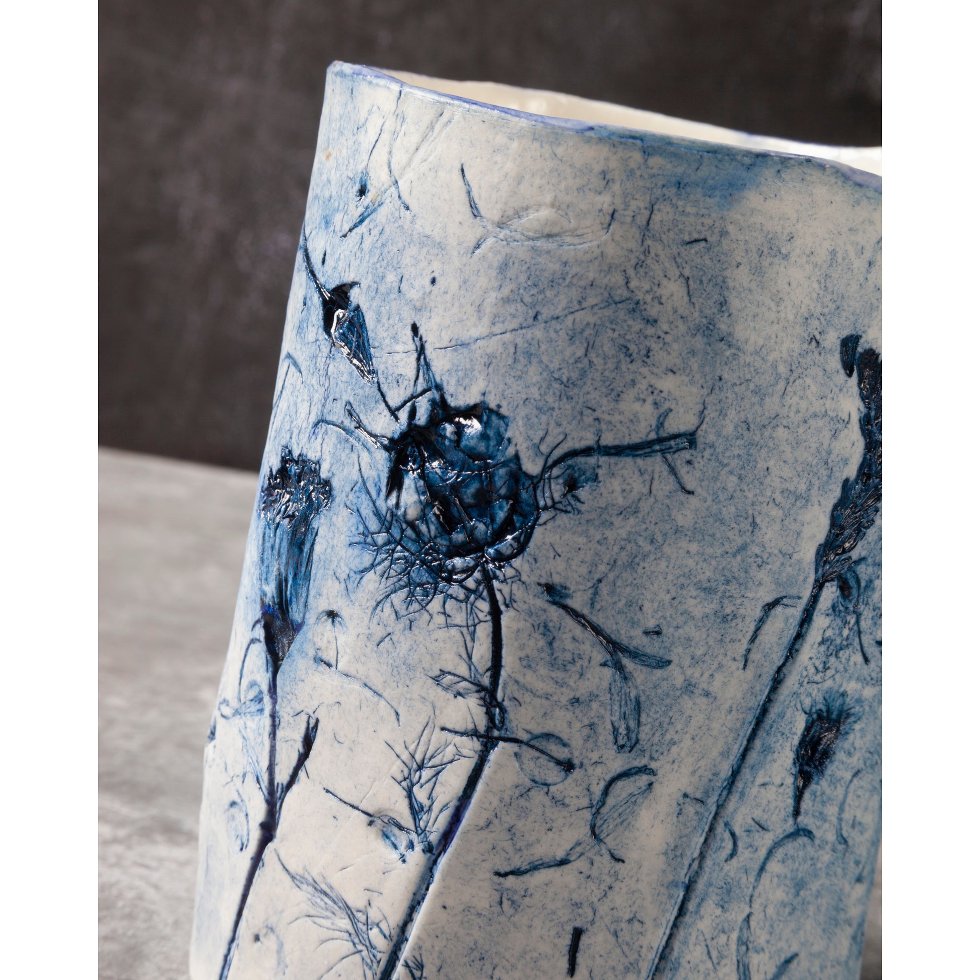 Ceramic vase with blue floral patterns on a neutral background