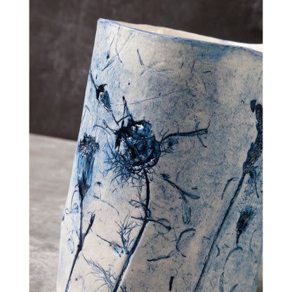 Ceramic vase with blue floral patterns on a neutral background