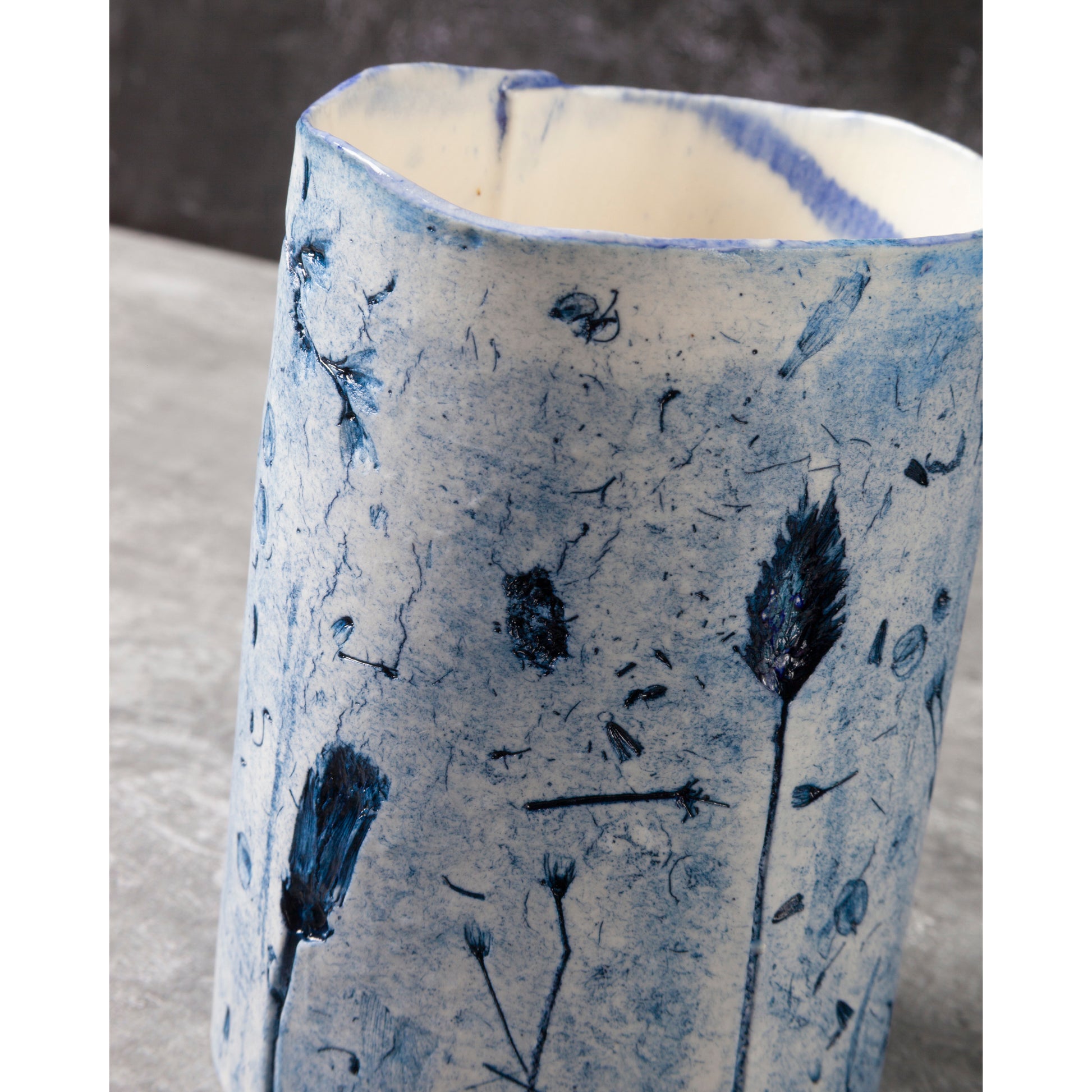 Ceramic vase with blue floral patterns on a neutral background