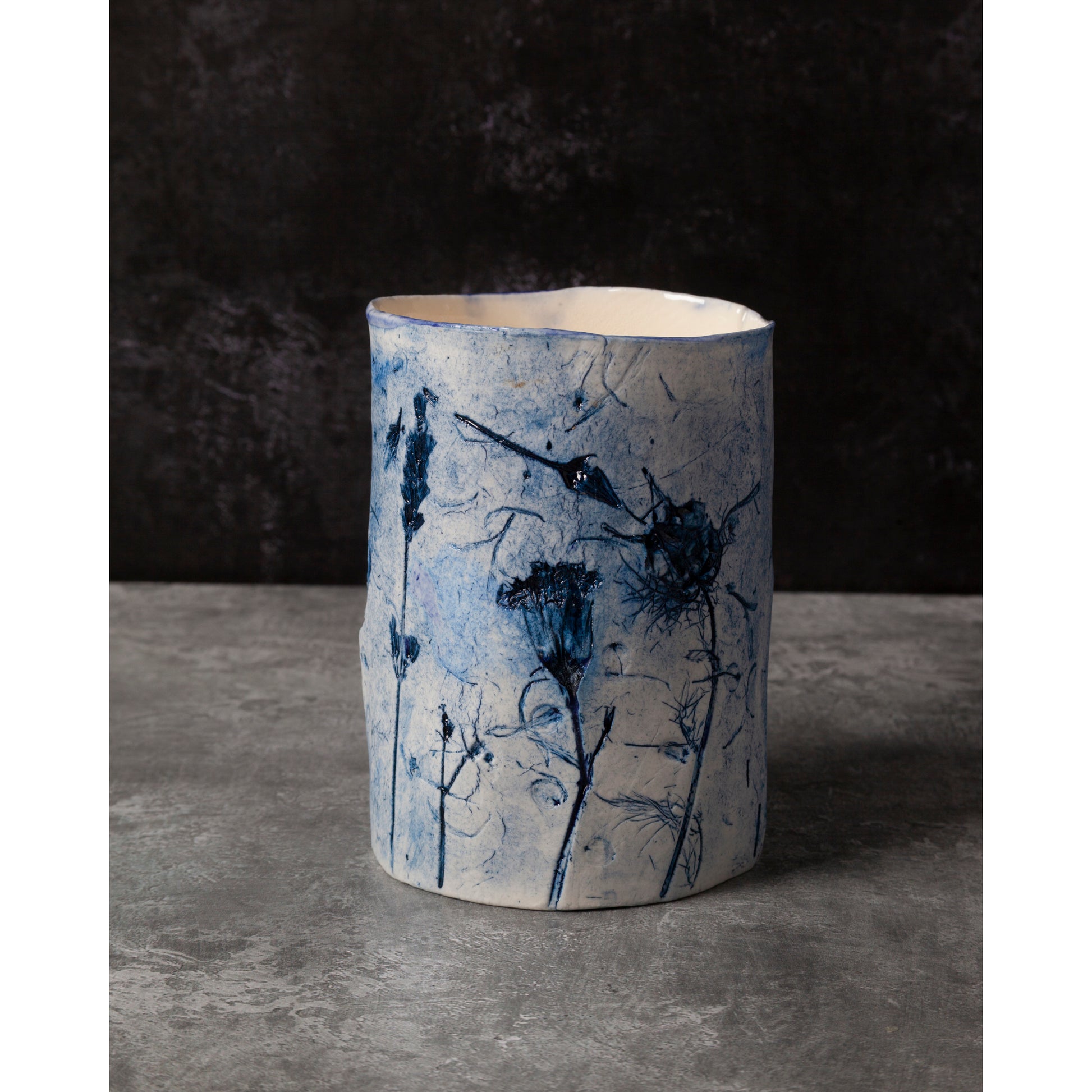 Ceramic vase with blue floral patterns on a dark background