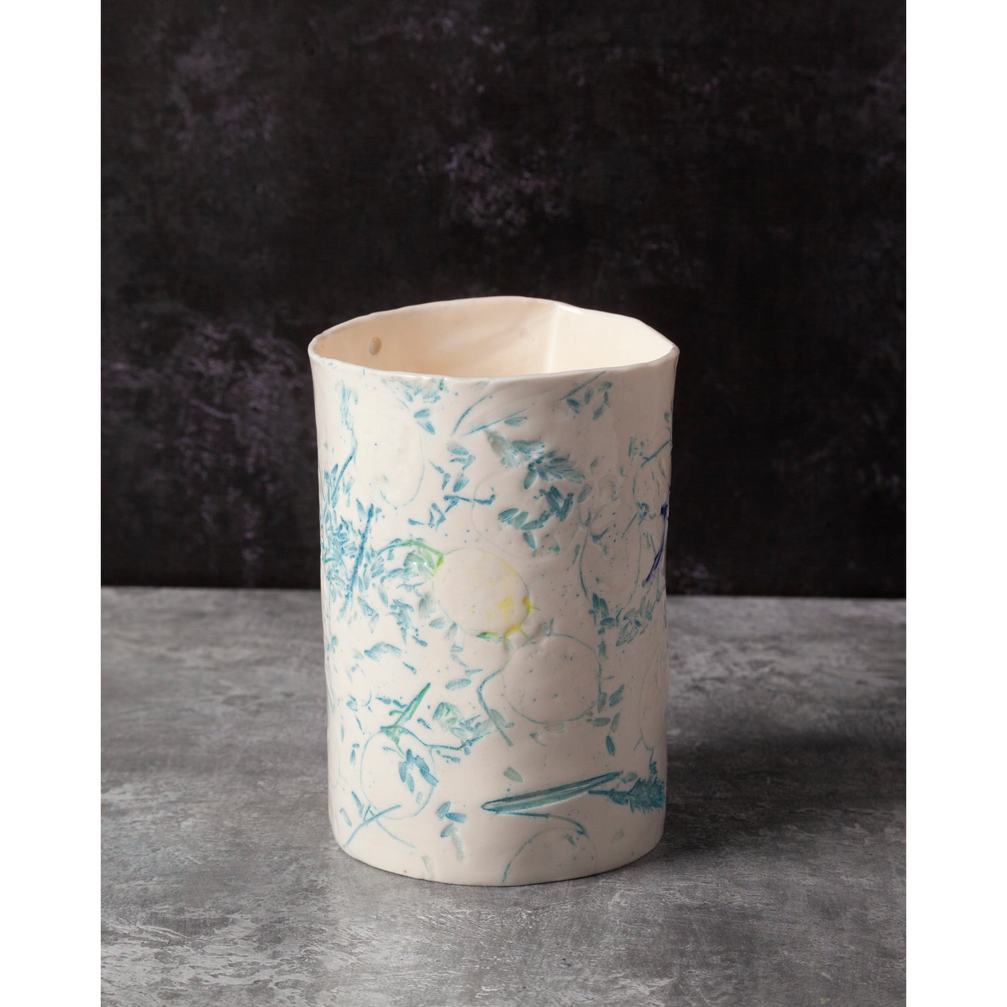 Ceramic vase with floral patterns on a dark background