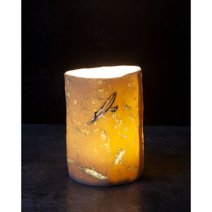 Cylindrical porcelain ceramic vase with abstract designs  using honesty seed heads, lavender, grasses and olive leaves photographed against a dark background
