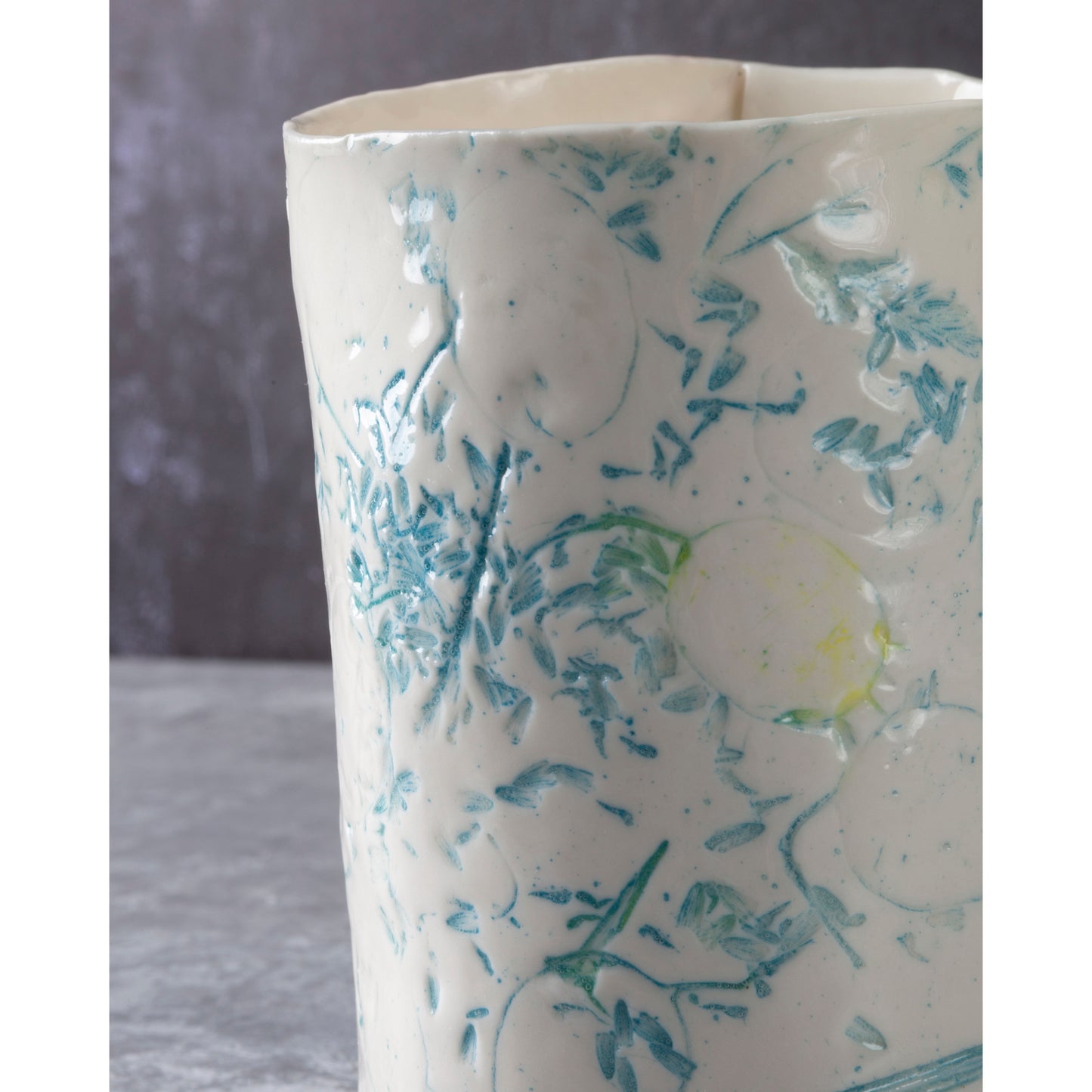 White ceramic vase with blue floral patterns on a gray background