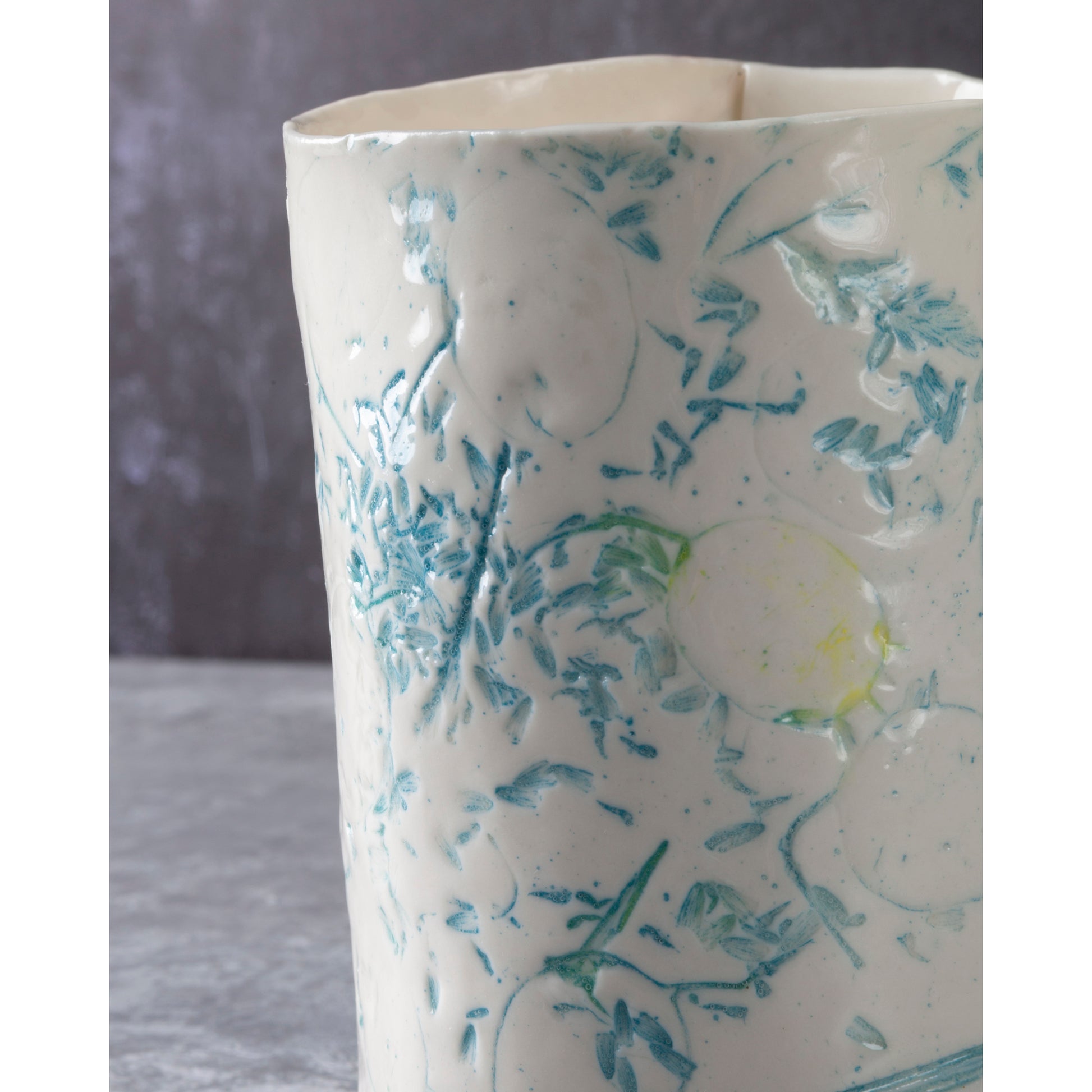 White ceramic vase with blue floral patterns on a gray background