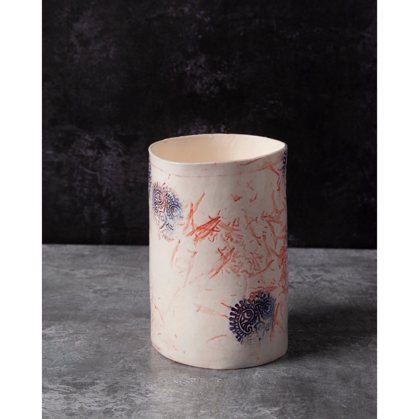 Ceramic vase with abstract patterns on a dark background