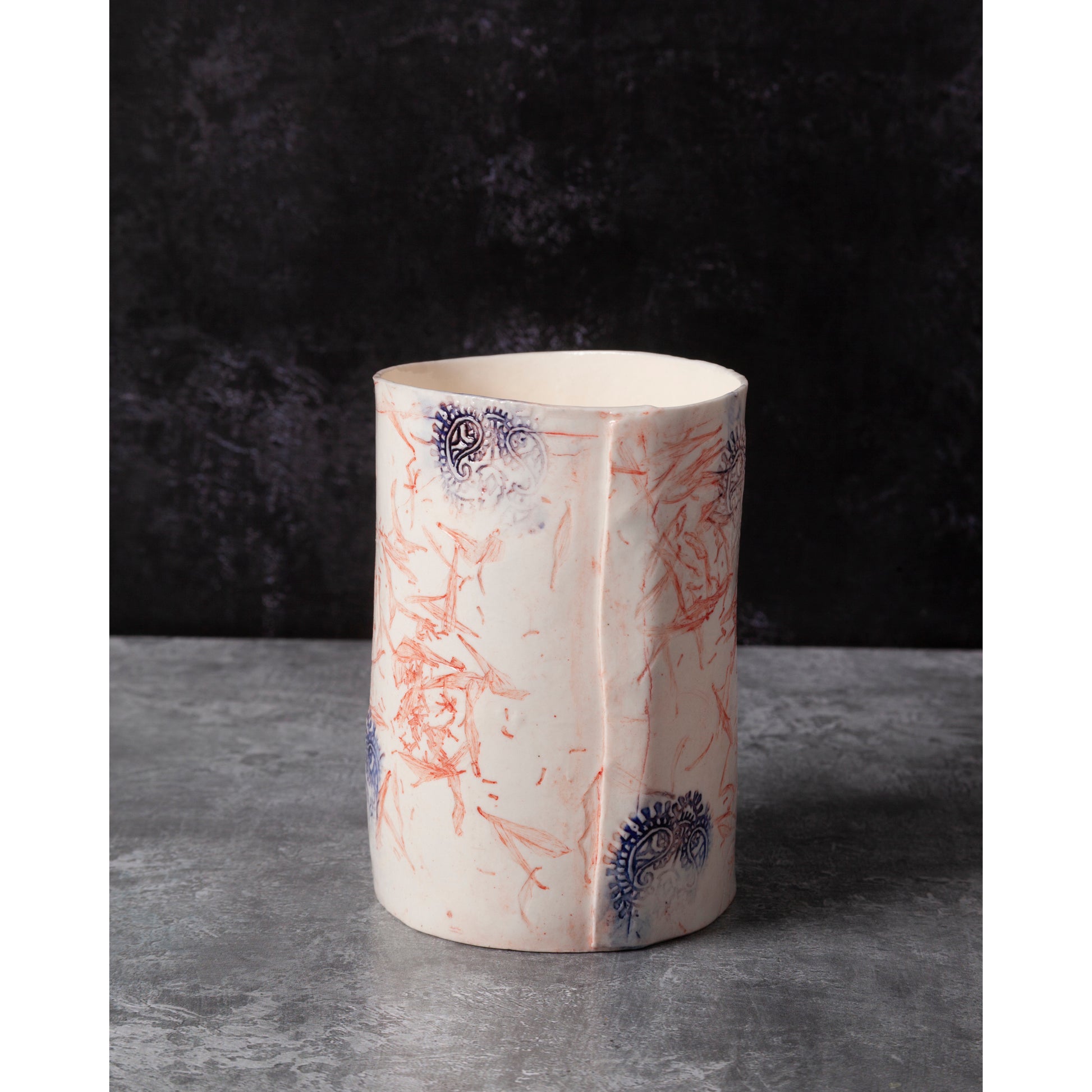 Decorative ceramic vase with abstract patterns. Photographed on a dark background