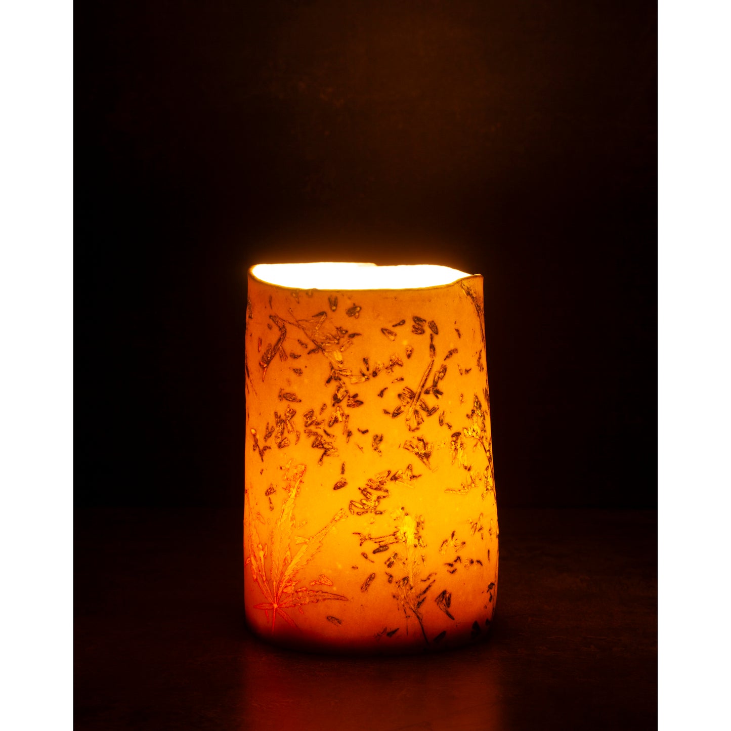 Ceramic night light / vase with lavender, grasses and leaf patterns on a white porcelain surface. High lights of blue and orange