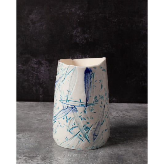 Ceramic night light / vase with blue abstract patterns using olive leaves and lavender seeds on a dark background