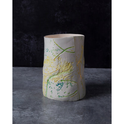 Ceramic vase / night light with green and yellow abstract patterns on a dark background