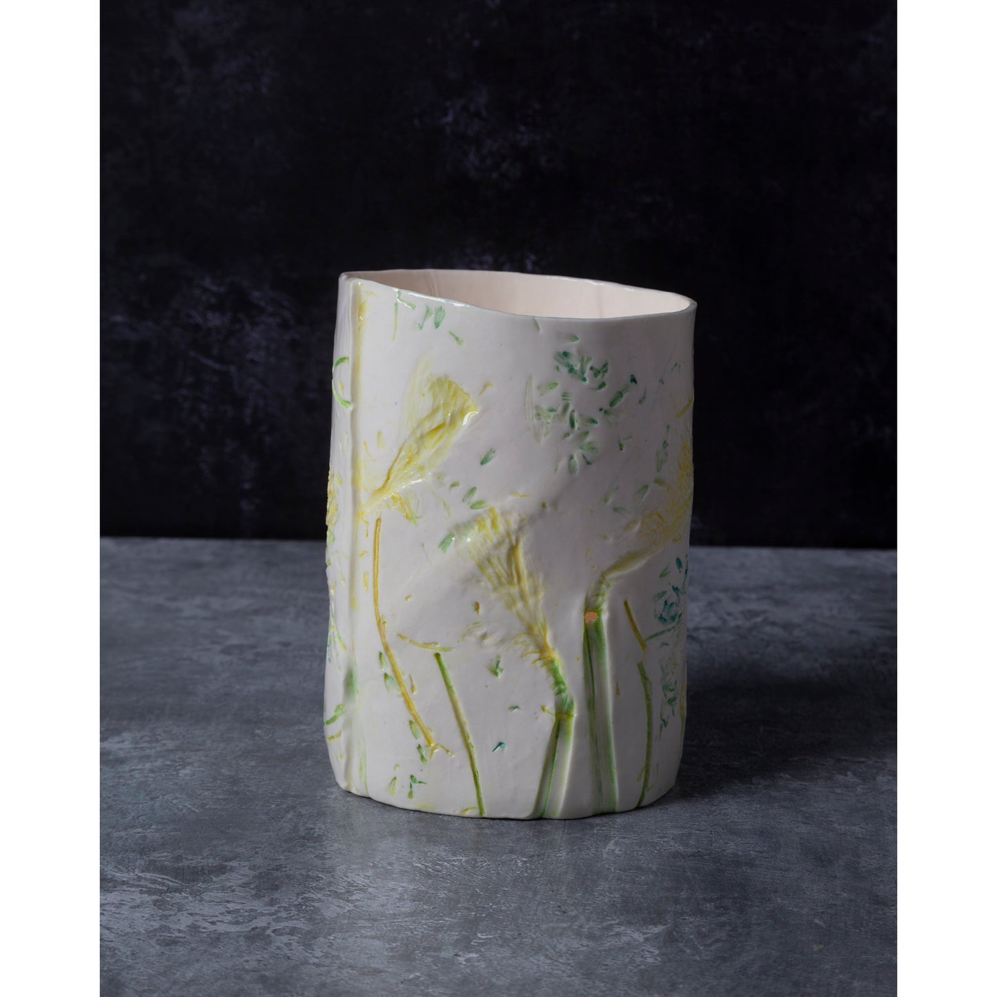porcelain vase / night light with floral patterns. Photographed against a dark background