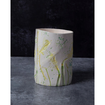 porcelain vase / night light with floral patterns. Photographed against a dark background