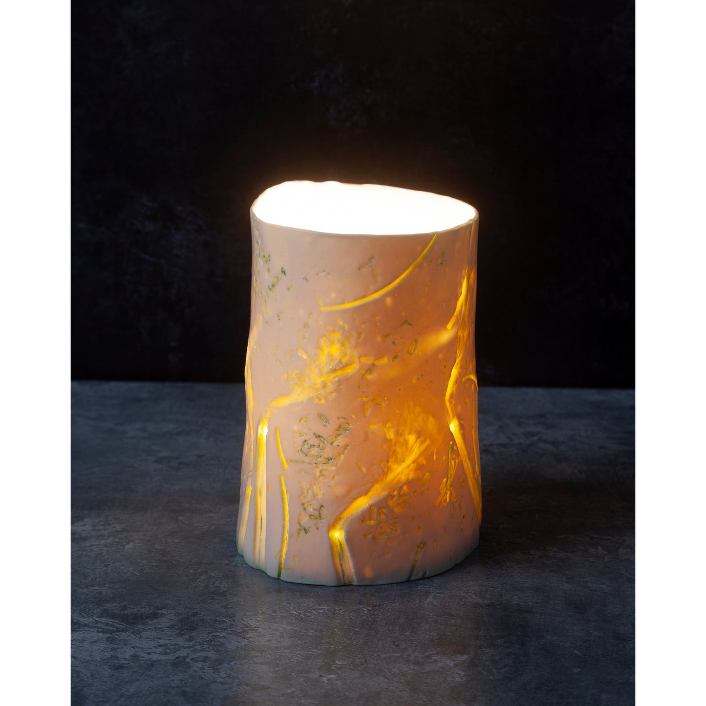 Decorative night light / vase with gold marbling on a dark background