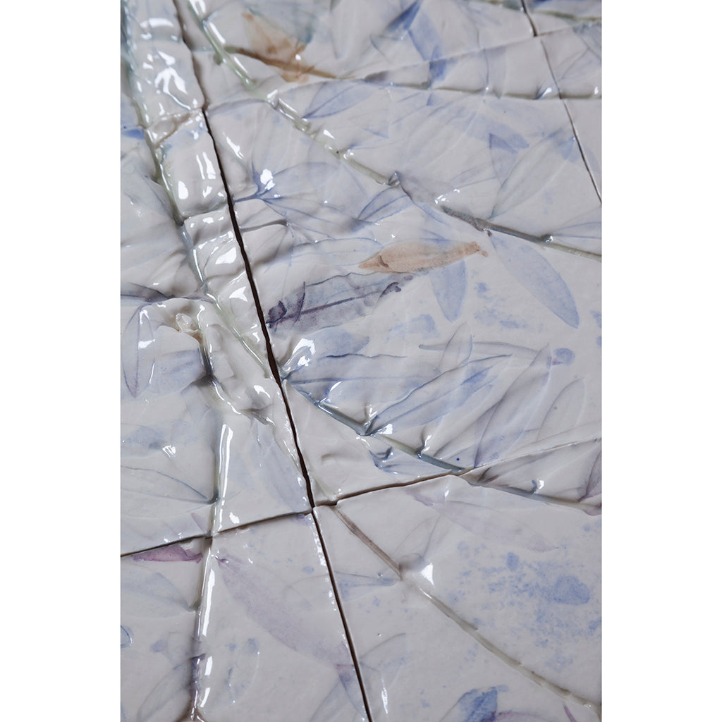 Detail of Large porcelain tile panel of an olive tree. Looking at leaves and branches. Blue and browny green colours on a white background