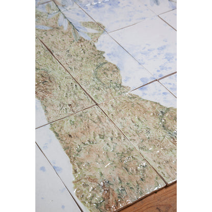 Detail of Large porcelain tile panel of an olive tree. Looking at trunk of tree. Blue, beige and green colors on a white background