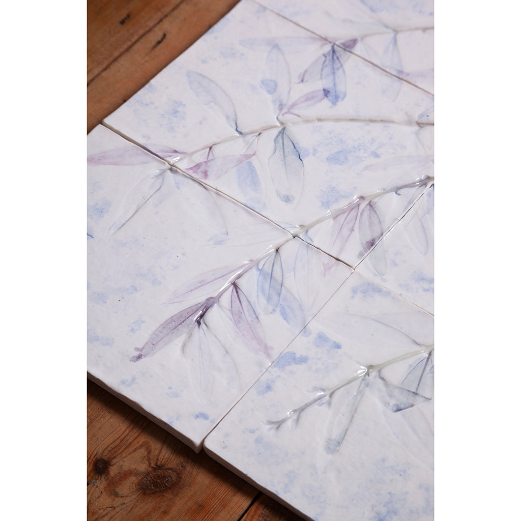 Detail of Large porcelain tile panel of an olive tree. Looking at leaves and branches. Blue colours on a white background