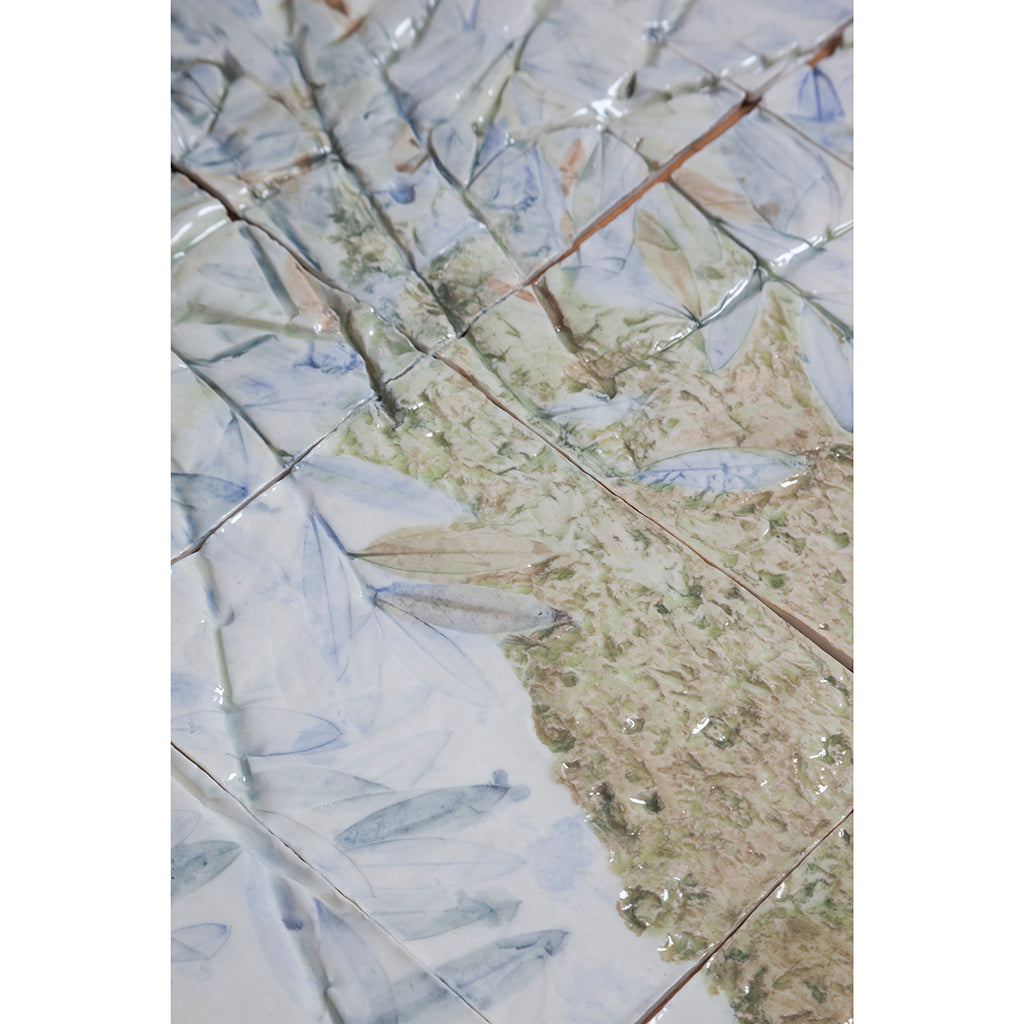 Detail of Large porcelain tile panel of an olive tree. Blue, beige and green colors on a white background